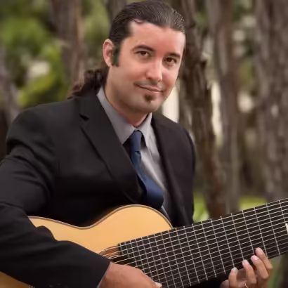 Eric Dickerson performing classical guitar music outdoors at K&M Music Company