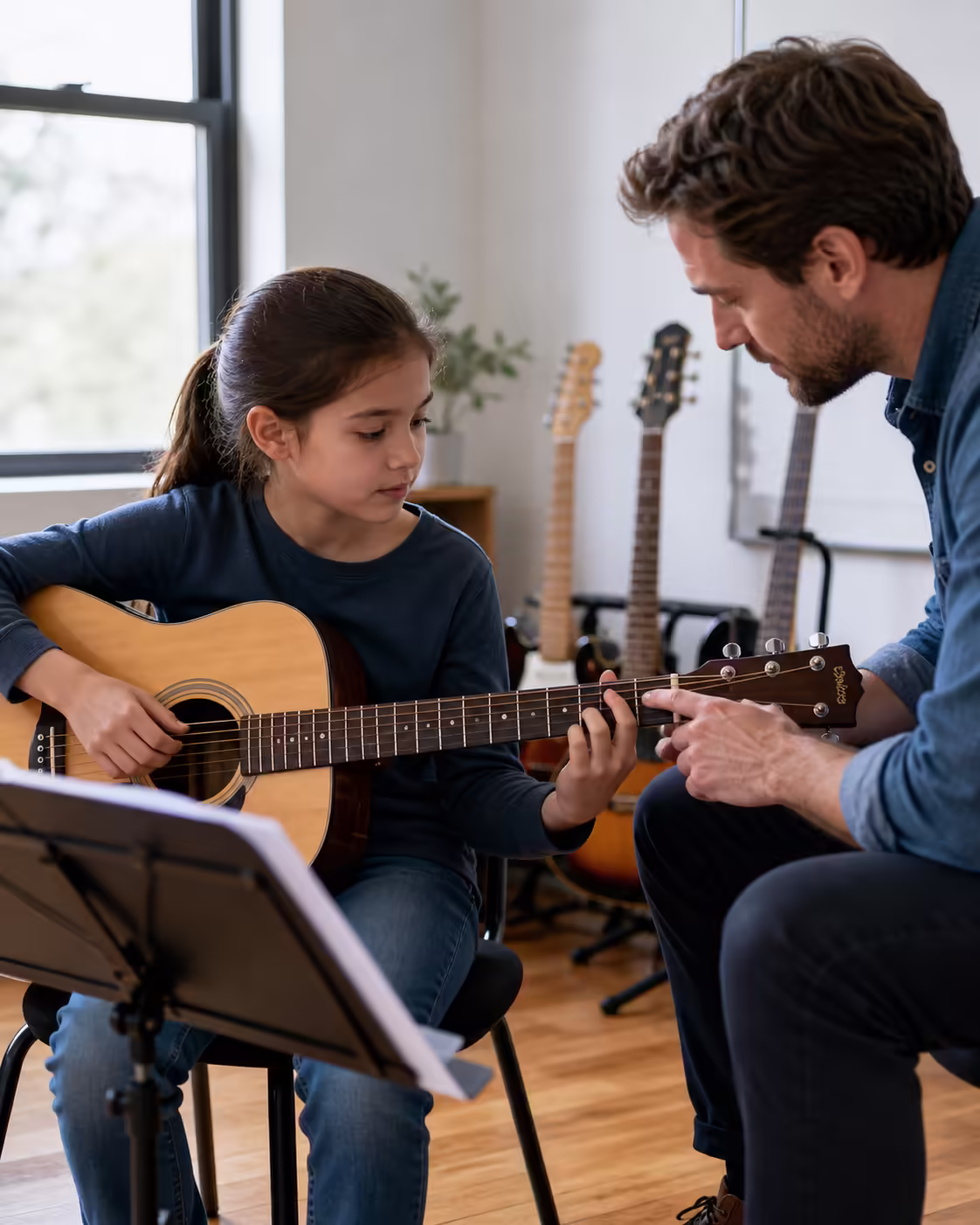 Guitar teacher helping student build good technique during lesson